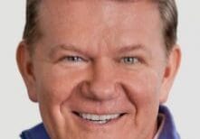 Smiling middle-aged man with light hair and blue eyes.