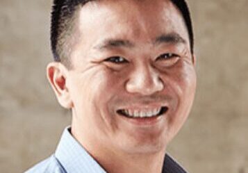 A man smiling warmly at the camera.