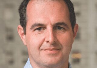 Portrait of a middle-aged man with a friendly expression.