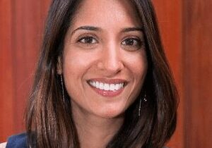 Portrait of a smiling woman with long brown hair.
