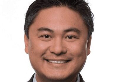 Portrait of a smiling man in a suit and tie.